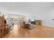 Sunny living room with hardwood floors and sliding glass doors leading to a small patio at 4709 Edwards Mill Rd # H, Raleigh, NC 27612