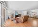 Open living room with hardwood floors, comfortable seating, and an adjacent dining area at 4709 Edwards Mill Rd # H, Raleigh, NC 27612
