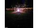Atmospheric backyard with a bonfire, swing, and string lights, creating a magical outdoor space at 5129 Neighbors Rd, Mebane, NC 27302