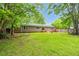 Spacious backyard showcasing lush lawn, mature trees, and a charming exterior at 5129 Neighbors Rd, Mebane, NC 27302