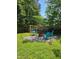 Cozy backyard featuring a swing set and outdoor seating area, perfect for relaxation and social gatherings at 5129 Neighbors Rd, Mebane, NC 27302