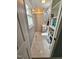 Cozy bathroom featuring updated tile, open shelving, and a shower-tub combination at 5129 Neighbors Rd, Mebane, NC 27302