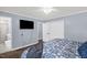 Cozy bedroom features a TV, closet, ensuite bathroom, and ceiling fan at 5129 Neighbors Rd, Mebane, NC 27302