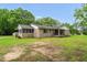 Charming brick ranch-style home featuring a screened porch and covered front porch, nestled on a spacious lot with mature trees at 5129 Neighbors Rd, Mebane, NC 27302