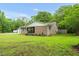 Brick home with inviting front porch, rocking chairs, and landscaping, set on a large lot with mature trees at 5129 Neighbors Rd, Mebane, NC 27302
