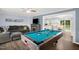 Spacious living room featuring a pool table, cozy fireplace, and comfortable seating, perfect for relaxation and entertainment at 5129 Neighbors Rd, Mebane, NC 27302
