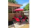 Outdoor patio area with a red umbrella and seating, perfect for relaxing and entertaining at 5129 Neighbors Rd, Mebane, NC 27302
