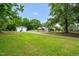 Expansive property featuring a well-maintained lawn, detached garage with dual doors, and a charming single-story home at 5129 Neighbors Rd, Mebane, NC 27302