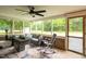Relaxing screened-in porch with comfortable seating and a view of the backyard at 5129 Neighbors Rd, Mebane, NC 27302