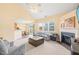 Open living area with neutral carpet, fireplace, adjacent dining area, and a sliding door to the backyard at 5312 Suntan Lake Dr, Raleigh, NC 27610