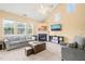 Bright living room featuring a fireplace, neutral carpet, and large windows offering plenty of natural light at 5312 Suntan Lake Dr, Raleigh, NC 27610