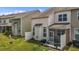 A view of the backyard with green grass, row of houses and screen porch at 5320 Jessip St, Morrisville, NC 27560