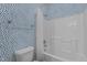 Bathroom with blue wallpaper, a combination shower and bathtub, and a toilet at 5320 Jessip St, Morrisville, NC 27560