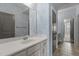 Cozy bathroom with white vanity and patterned wallpaper, offering a glimpse into another room at 5320 Jessip St, Morrisville, NC 27560