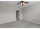 Neutral bedroom with carpeted floors and grey walls. A door opens to another room at 5320 Jessip St, Morrisville, NC 27560