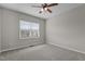 Neutral bedroom featuring a ceiling fan, window with blinds, and cozy carpeted floors at 5320 Jessip St, Morrisville, NC 27560