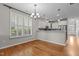 Bright dining area showcases hardwood floors, natural light, a chandelier, and an open view into the kitchen at 5320 Jessip St, Morrisville, NC 27560