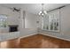 Dining area features hardwood floors, a modern chandelier, and large window with shutter-style blinds at 5320 Jessip St, Morrisville, NC 27560