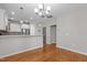 This dining area boasts hardwood floors, a modern chandelier, and an open layout to the kitchen at 5320 Jessip St, Morrisville, NC 27560