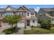 Inviting townhome with a well-manicured lawn, stone accents, attached garage, and welcoming entryway at 5320 Jessip St, Morrisville, NC 27560