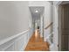 Bright hallway features hardwood floors, wainscoting, and staircase leading to the upper level at 5320 Jessip St, Morrisville, NC 27560
