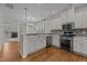 Bright kitchen with stainless steel appliances, white cabinetry, and a mosaic tile backsplash at 5320 Jessip St, Morrisville, NC 27560