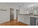 Open-concept kitchen featuring stainless steel appliances, mosaic backsplash, and hardwood floors at 5320 Jessip St, Morrisville, NC 27560