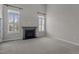 Inviting living room offers neutral carpet, plantation shutters, a cozy fireplace, and an exterior access door at 5320 Jessip St, Morrisville, NC 27560