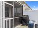 A screened porch with a grill and a table for relaxing outside at 5320 Jessip St, Morrisville, NC 27560