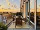 Outdoor balcony featuring table and chairs with city views and glass railings at 601 W Rosemary St # 416, Chapel Hill, NC 27516