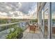 Outdoor balcony featuring table and chairs with bright views and glass railings at 601 W Rosemary St # 416, Chapel Hill, NC 27516