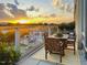 Outdoor balcony featuring table and chairs with colorful sunset views and glass railings at 601 W Rosemary St # 416, Chapel Hill, NC 27516