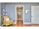 Bedroom with yellow chair and view of walk-in closet and en suite bathroom at 601 W Rosemary St # 416, Chapel Hill, NC 27516