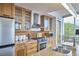 Modern kitchen with stainless steel appliances, wood cabinets, and tiled backsplash at 601 W Rosemary St # 416, Chapel Hill, NC 27516