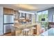 Modern kitchen with stainless steel appliances, wood cabinets, and eat-in island near a work desk at 601 W Rosemary St # 416, Chapel Hill, NC 27516