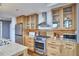 Bright kitchen with stainless steel appliances, wooden cabinets, and granite countertops at 601 W Rosemary St # 416, Chapel Hill, NC 27516