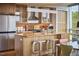Modern kitchen with stainless steel appliances, wood cabinets, island with breakfast bar, and modern decor at 601 W Rosemary St # 416, Chapel Hill, NC 27516