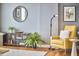 Cozy living room featuring hardwood floors, yellow chair, and plants at 601 W Rosemary St # 416, Chapel Hill, NC 27516