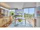 Open floorplan showcasing modern kitchen with eat-in island, adjacent to dining area with large windows at 601 W Rosemary St # 416, Chapel Hill, NC 27516