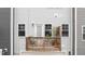 Balcony with grey wood floors, a table and chairs, and a view of the home's exterior at 6415 Mentor Pl, Raleigh, NC 27616