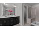 Bathroom features a double vanity, large mirror, and glass-enclosed shower with tiled walls and a built-in seat at 6415 Mentor Pl, Raleigh, NC 27616