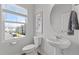 Powder room featuring a pedestal sink, toilet, and window view at 6415 Mentor Pl, Raleigh, NC 27616