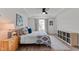 Bright bedroom with a ceiling fan, tray ceiling, and stylish decor and furnishings at 6415 Mentor Pl, Raleigh, NC 27616