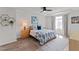 Cozy bedroom with a stylish bed, a ceiling fan, and natural light from the window at 6415 Mentor Pl, Raleigh, NC 27616