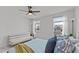 Bright bedroom with neutral paint, a sofa, ceiling fan and natural light from the two windows at 6415 Mentor Pl, Raleigh, NC 27616
