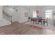 Bright dining room with modern light fixture, and wooden floors at 6415 Mentor Pl, Raleigh, NC 27616