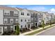 Modern townhomes with charming exteriors, stone accents, and well-manicured front yard landscaping at 6415 Mentor Pl, Raleigh, NC 27616