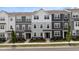 Charming townhome exterior featuring a mix of stone accents and neutral colored siding and manicured landscaping at 6415 Mentor Pl, Raleigh, NC 27616