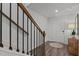 Foyer with modern staircase, wood floors, and stylish decor, creating a welcoming entrance at 6415 Mentor Pl, Raleigh, NC 27616