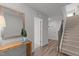 Inviting foyer with wood-look floors, staircase, and stylish decor, creating a warm and welcoming atmosphere at 6415 Mentor Pl, Raleigh, NC 27616